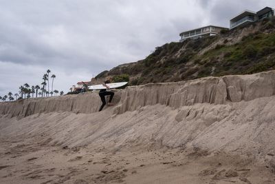 Sea level rise is reshaping a beloved California beach town and threatening a busy rail line