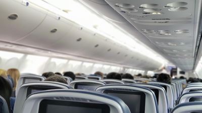 American Airlines passenger sees older man beside her texting about her body and the physical contact between them. She calls him out so FAs reward her