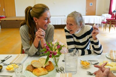 Princess Kate shares crisps and eats soup with elderly residents at village lunch group