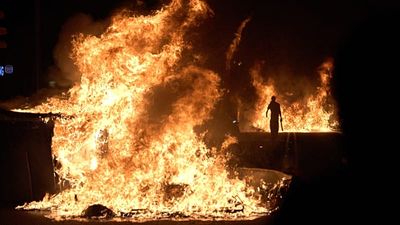 Barcelona housing protest erupts into clashes as barricades burn