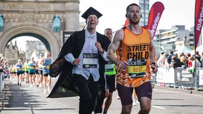 An Oxford professor broke a Guinness record by running a marathon in academic dress for charity