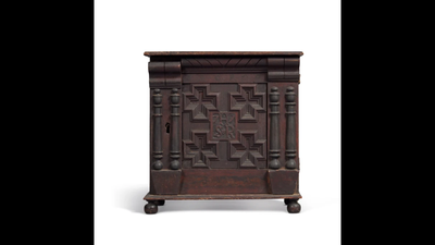 A battered 1677 wooden cabinet sold for $1.64 million after a key photo revealed its rarity