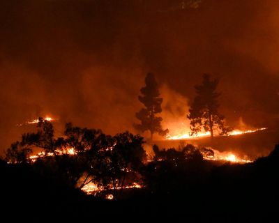 Brush fires set homes ablaze in southern California as it braces for more hot weather