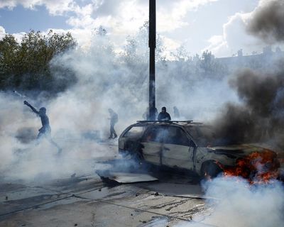 Buildings set ablaze and more than 1,800 arrested as police clash with protesters across France