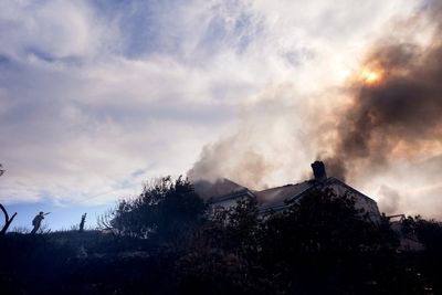 Fire crews battle Southern California blaze that burned 6 homes, led to the evacuation of 16,000