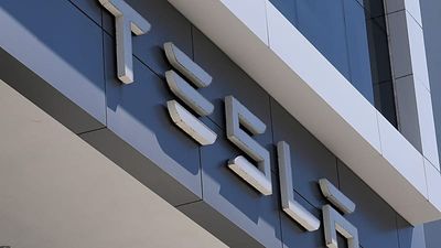Tesla's profit drops as it explores a possible merger with Musk's other public company, SpaceX