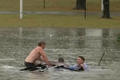 TV news reporter rescues driver from sinking car trapped in floods