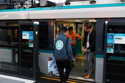 Metro-themed shirts, ‘We love public transport’ signs and a kiss at Bankstown: Sydney’s newest train line opens