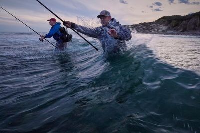 Fishermen cast for striped bass as the species faces decline, in photos