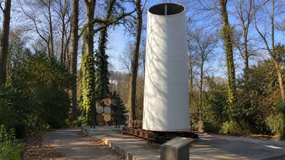 Reclaimed Blade Becomes Landmark: Turbine wing sculpture marks Columbia Pike; coins from 117 countries