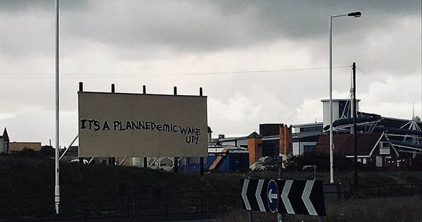 Nurse's anger after coronavirus 'conspiracy theory' graffiti is painted on billboard